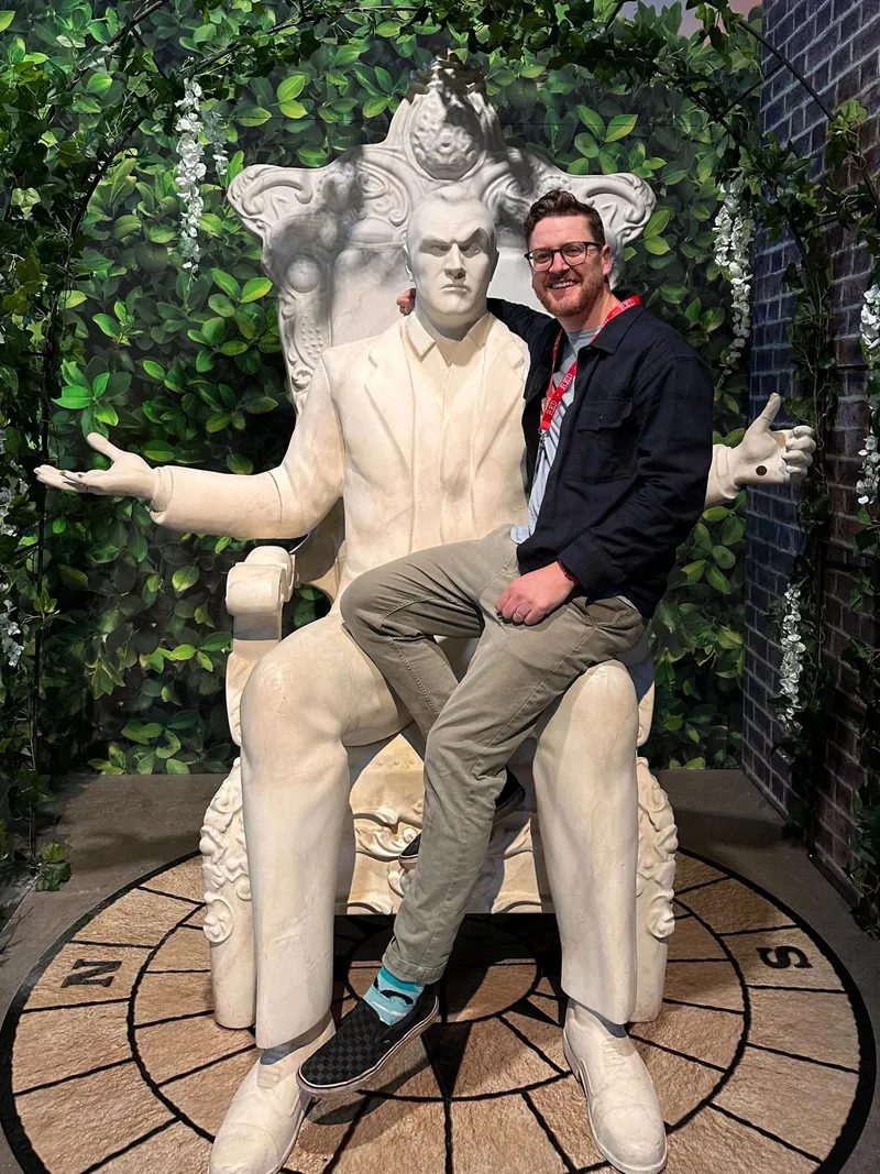 Martin sitting on a large sculpture of a throne